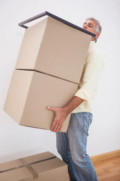 Man balancing heavy cardboard boxes — Stock Photo, Image