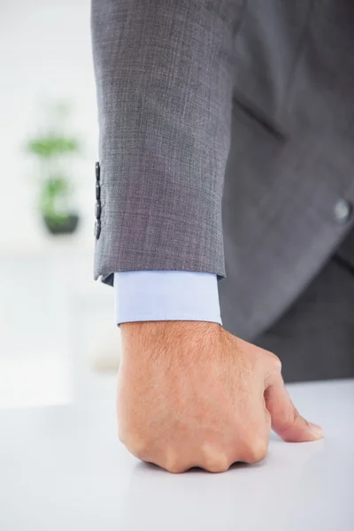 Businessmans fist clenched over desk — Stock Photo, Image
