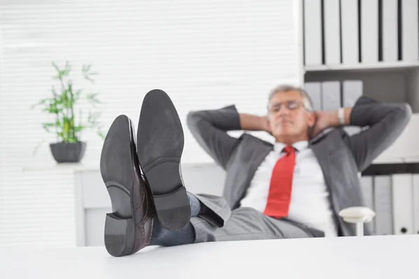 Relaxed businessman with his feet up — Stock Photo, Image