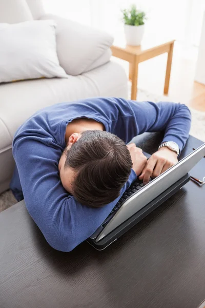 Ung man sitter på golvet med laptop — Stockfoto