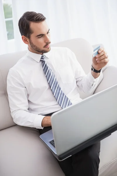 Businessman shopping online on his couch — Stock Photo, Image