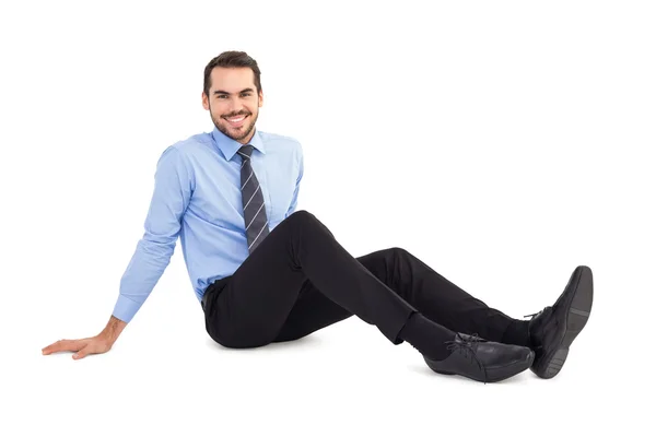 Happy businessman sitting on floor — Stock Photo, Image