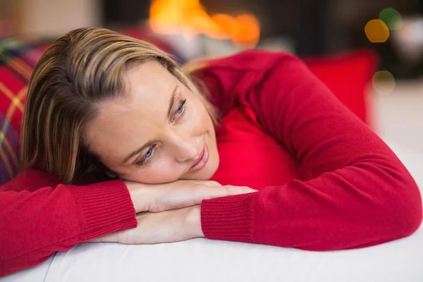 Relaxed blonde lying on the couch at christmas — Stock Photo, Image