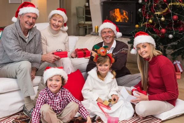 Happy family at christmas holding gifts — Stock Photo, Image