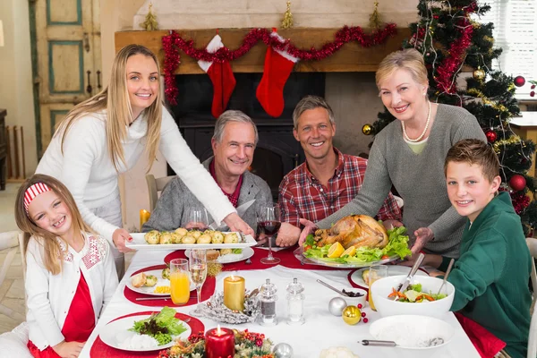 Two women serving christmas dinner to their family — Stock Photo, Image