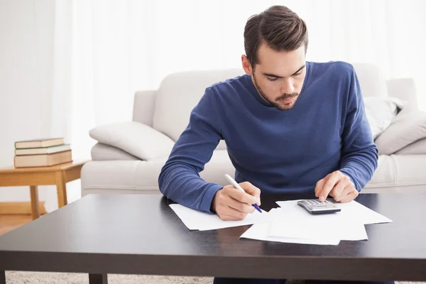 Young man paying his bills Royalty Free Stock Photos