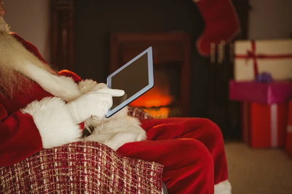 Mid section of santa touching tablet — Stock Photo, Image