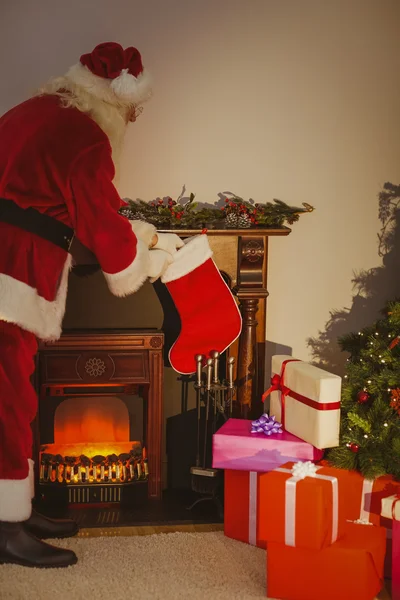 Father christmas stocking gifts at christmas eve — Stock Photo, Image