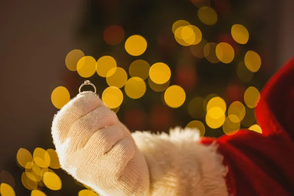 Hand of father christmas holding engagement ring — Stock Photo, Image