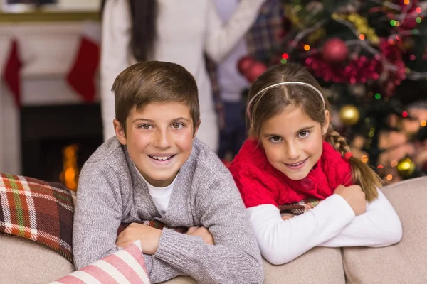 Brother and sister leaning on the couch — Stock Photo, Image