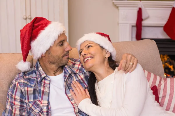 Sorrindo casal abraçando no sofá — Fotografia de Stock