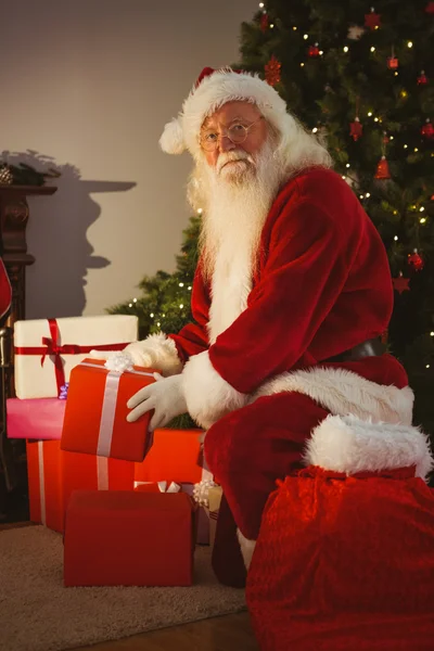 Portrait of santa delivering gifts at christmas eve Stock Image