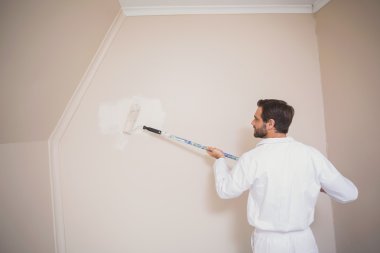 Painter painting the walls white clipart