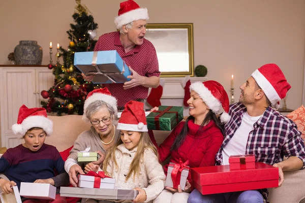 Grandfather giving gift to his family — Stock Photo, Image