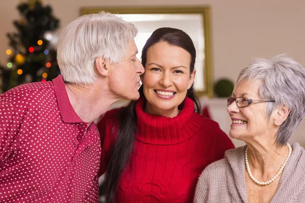 Grandfather kissing the mother at christmas — Stock Photo, Image