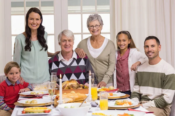 Happy extended family at christmas dinner posing at camera — Stock Photo, Image