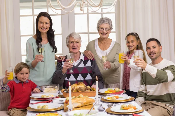 Happy extended family at christmas toasting at camera — Stock Photo, Image