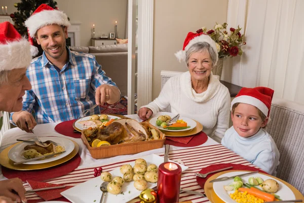 Father in santa hat serving roast turkey at christmas — Stock Photo, Image