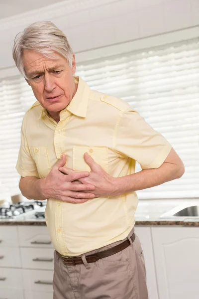 Senior man clutching his chest — Stock Photo, Image