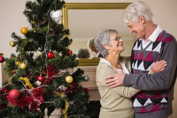 Senior couple decorating their christmas tree — Stock Photo, Image