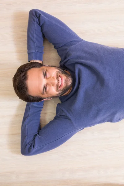 Ευτυχισμένος άνθρωπος ξαπλωμένος στο πάτωμα — Φωτογραφία Αρχείου