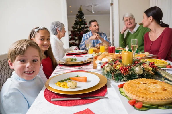 Portrait of brother and sister during christmas dinner Royalty Free Stock Images