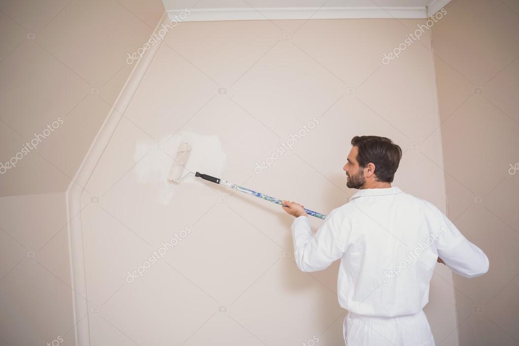 Painter painting the walls white Stock Photo by ©Wavebreakmedia 60888171