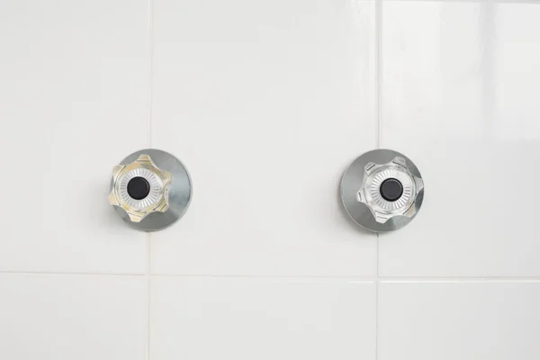 Taps on tiled wall — Stock Photo, Image