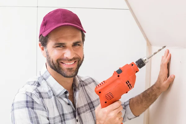 Construction worker drilling hole in wall — Stock Photo, Image