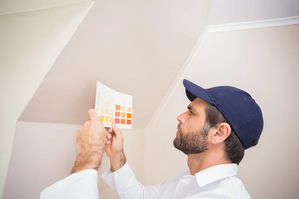 Painter consulting a colour chart — Stock Photo, Image