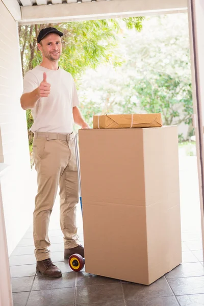 Delivery man with trolley of boxes — Stock Photo, Image