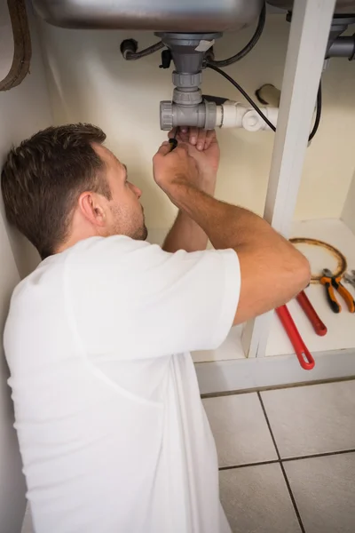 Plumber fixing under the sink — Stock Photo, Image