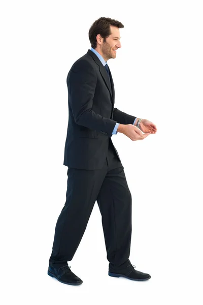 Handsome businessman holding hand out — Stock Photo, Image