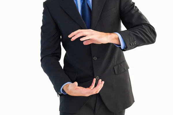 Mid section of a businessman presenting with his hands — Stock Photo, Image