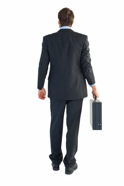 ブリーフケースを保持している実業家の背面図 — ストック写真