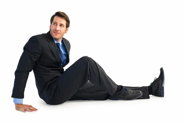 Biznesmen w garnitur, siedząc na podłodze — Zdjęcie stockowe