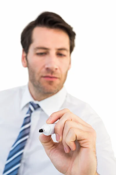 Focused businessman writing with marker — Stock Photo, Image