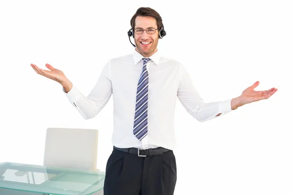 Hombre de negocios sonriente presentando y usando auriculares — Foto de Stock