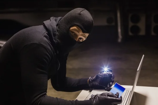 Robber shopping online while making light — Stock Photo, Image