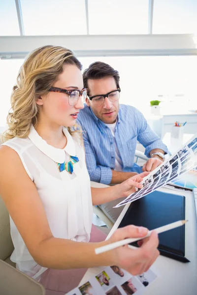 Two happy photo editors working with contact sheets — Stock Photo, Image