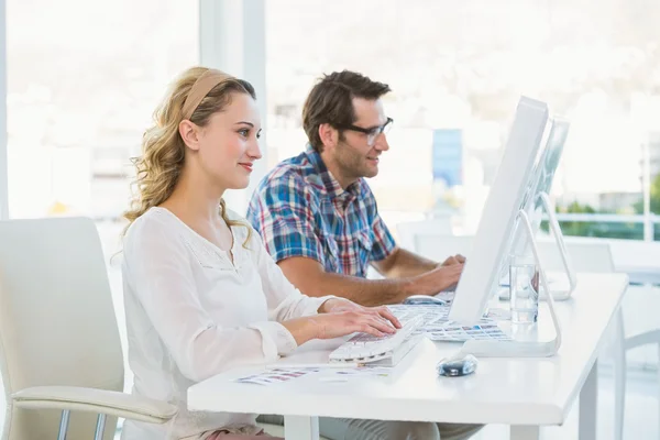 Thoughtful photo editors looking at their screens — Stock Photo, Image