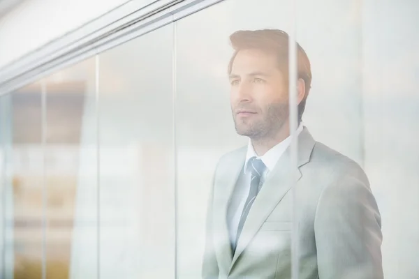 Retrato del empresario reflexivo a través de la ventana — Foto de Stock