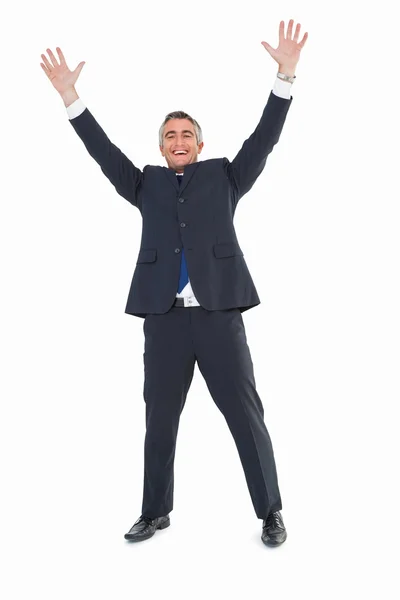 Happy businessman in suit with arms up — Stock Photo, Image