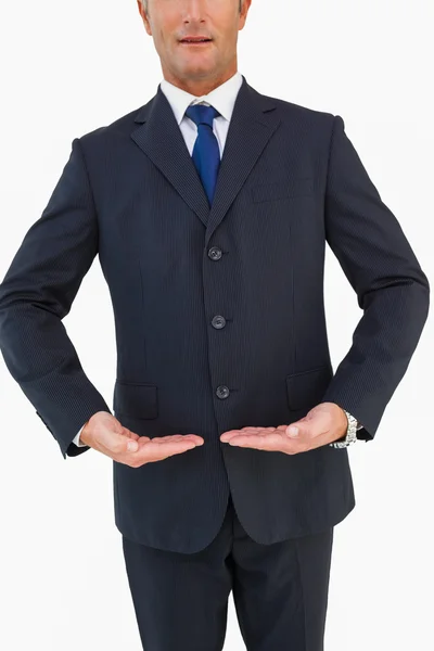 Mid section of a businessman in suit with hands out — Stock Photo, Image