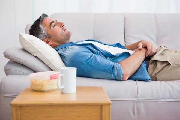 Relaxed man lying on the couch — Stock Photo, Image