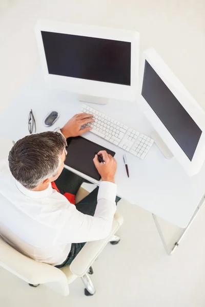 Businessman using computer and tablet — Stock Photo, Image