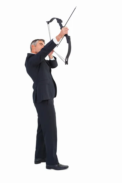 Elegant businessman stretching a bow — Stock Photo, Image