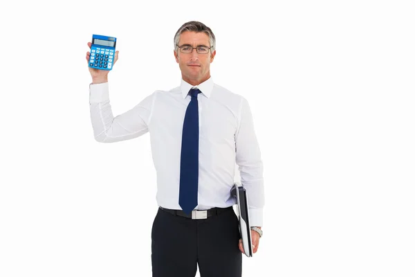 Businessman showing calculator while holding his laptop — Stock Photo, Image