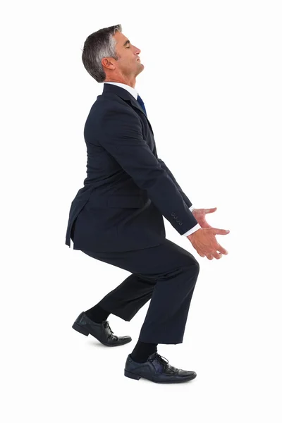 Businessman in suit carrying something — Stock Photo, Image