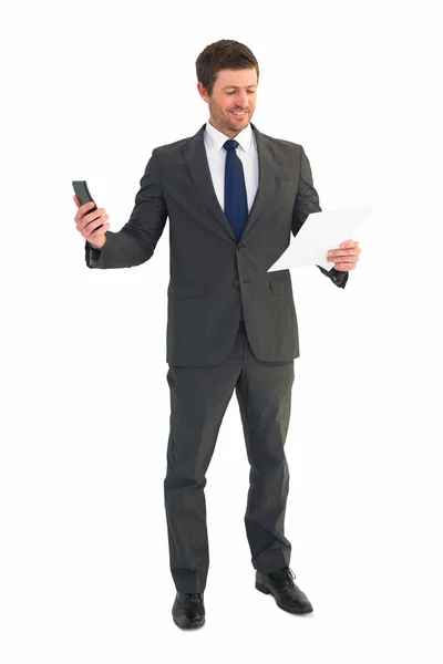 Businessman sending text holding page — Stock Photo, Image